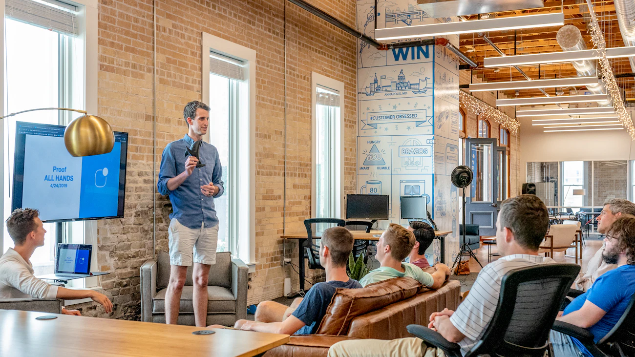 Trainer presenting to a group in a modern workspace
